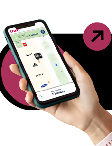 Hand holding a smartphone displaying the truvr app